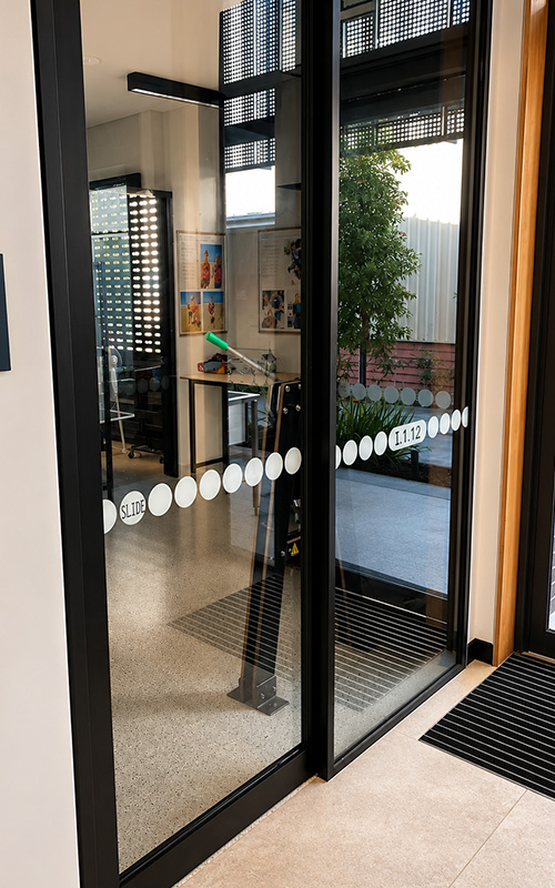 Frameless glass doors with black aluminium framing